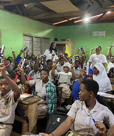 Some students showing their math set they've received from the Growth Mindset Development Foundation