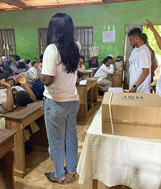 A Growth Mindset Development Foundation volunteer having a prayer session with some students.